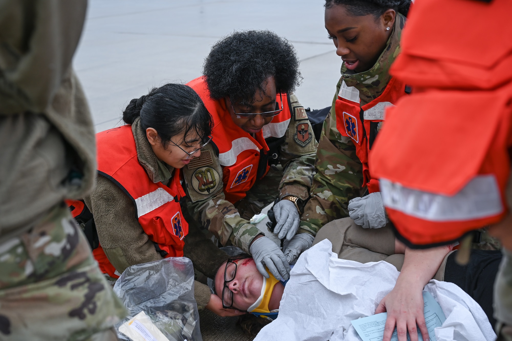 U.S. Air Force Airmen from the 47th Medical Group place a neck brace on a simulated pregnant woman during a Major Accident Response Exercise (MARE) on the flight line at Laughlin Air Force Base, Texas, Dec. 14, 2023