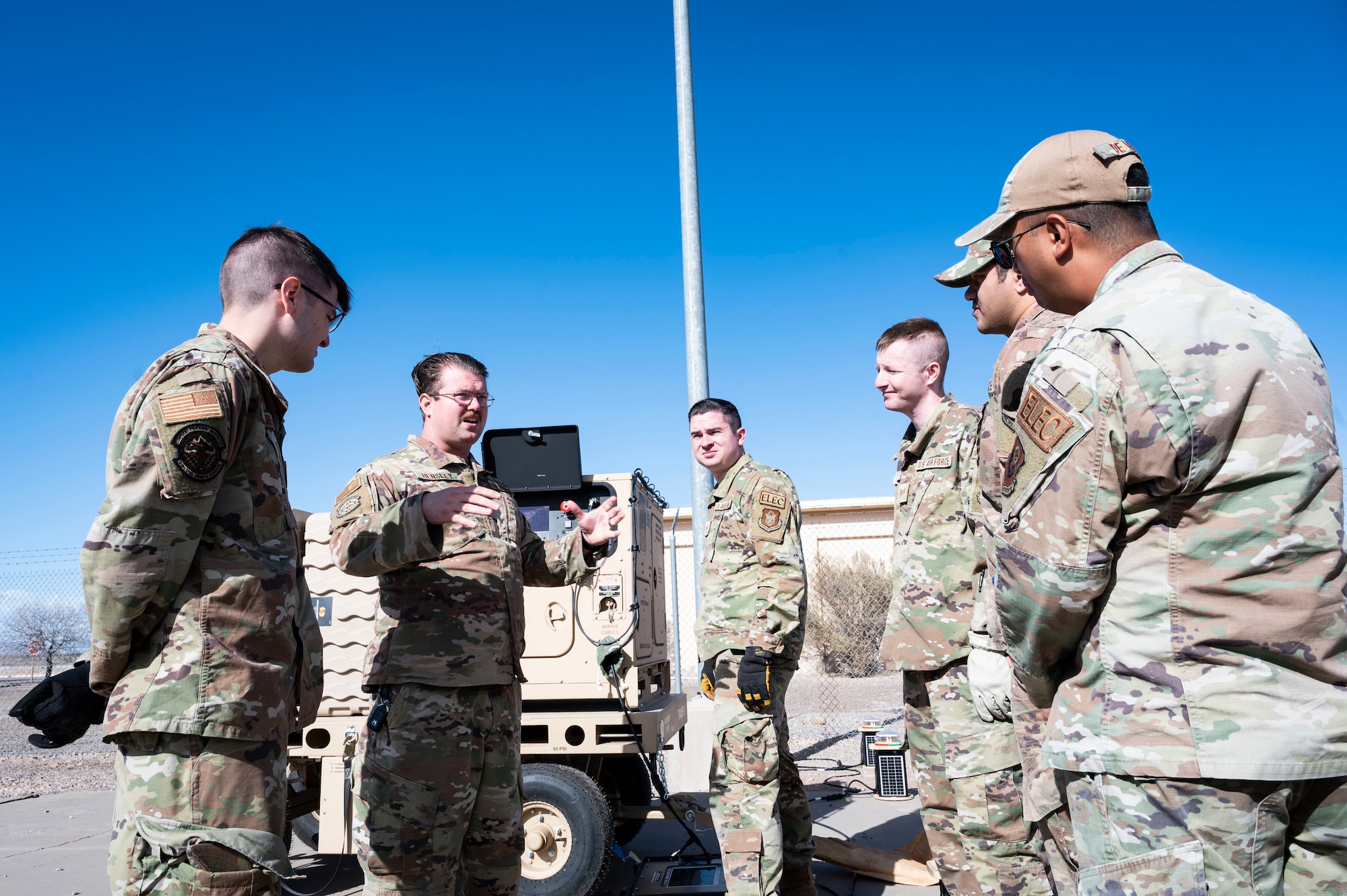 U.S. Air Force Staff Sgt. Dallas Hensley, 635th Materiel Maintenance Squadron contingency training noncommissioned officer in charge, gives a briefing to a group of Airmen about setting up a new Expeditionary Aircraft Lighting System at Holloman Air Force Base, New Mexico, Dec. 14, 2023. The new EALS model enhances the Air Force’s rapid response in urgent missions, ensuring swift airfield setup in critical scenarios. (U.S. Air Force photo by Airman 1st Class Isaiah Pedrazzini)
