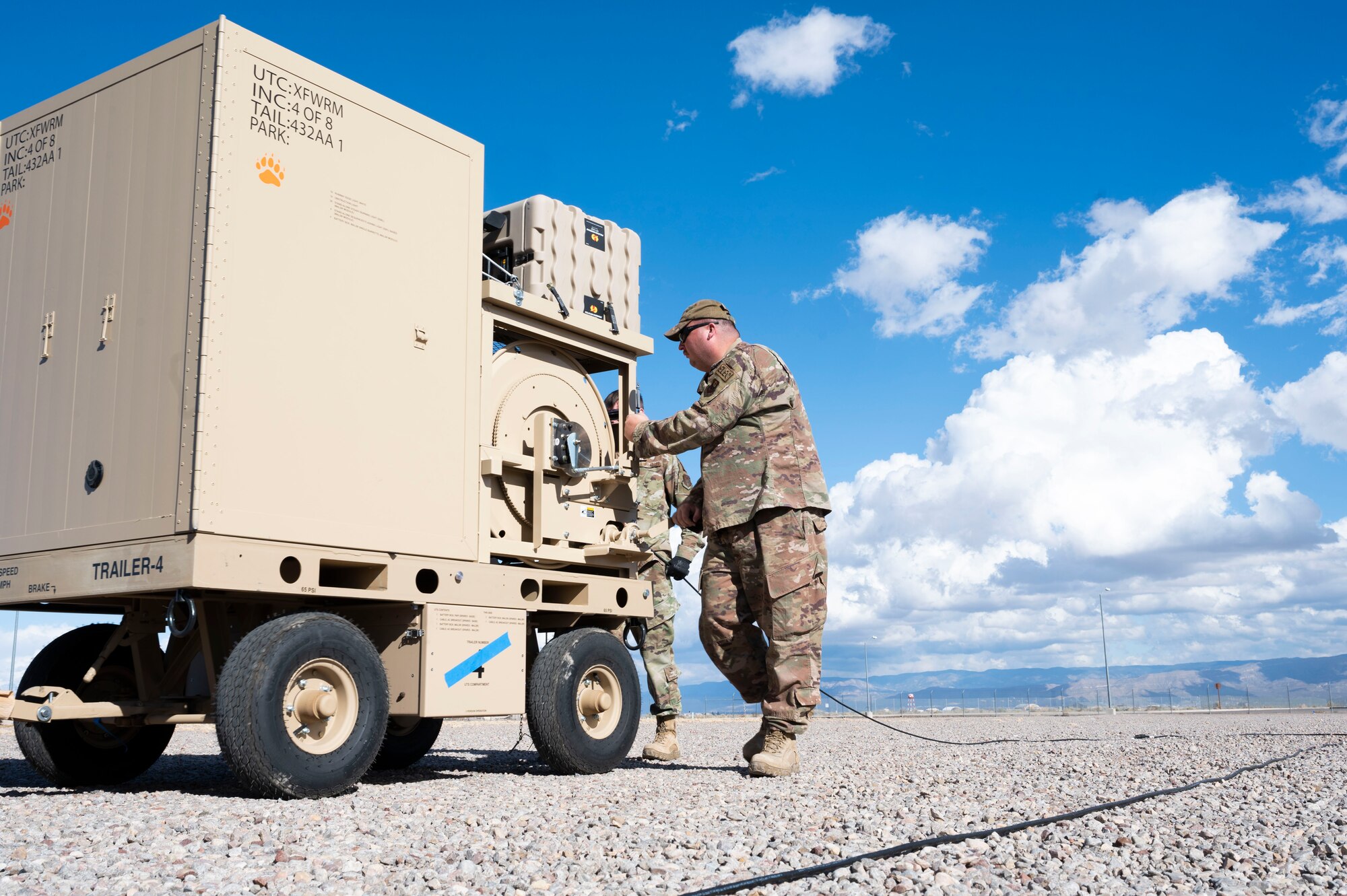 U.S. Air Force Staff Sgt. Robert Cowart, 1st Special Operations Civil Engineer Squadron electrician, rolls up wiring for an Expeditionary Aircraft Lighting System layout during a training course at Holloman Air Force Base, New Mexico, Dec. 14, 2023. With the upgraded EALS, the Air Force has the capability to efficiently provide temporary landing areas for aircraft in deployed environments. (U.S. Air Force photo by Airman 1st Class Isaiah Pedrazzini)