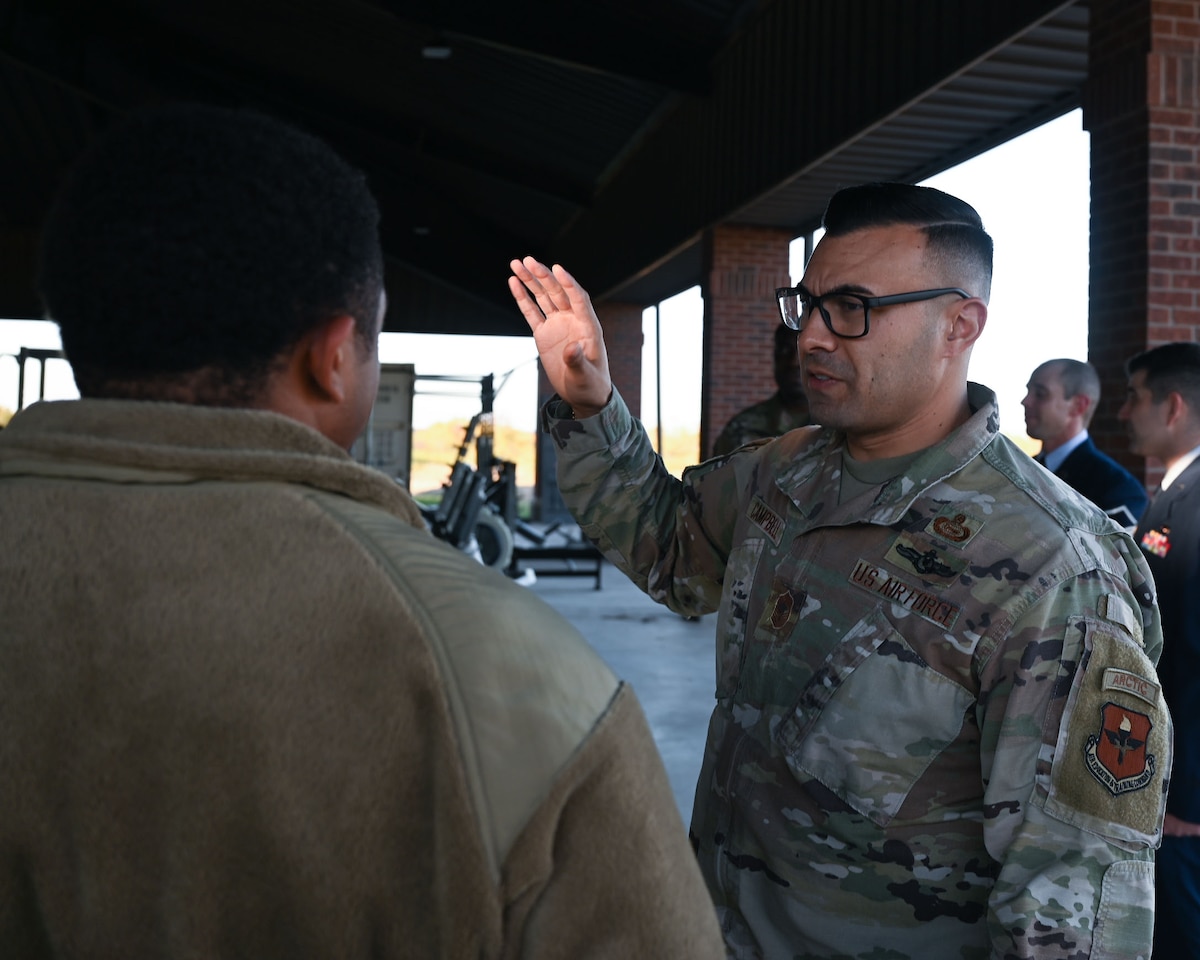 U.S. Air Force Chief Master Sgt. Christopher Campbell, 316th Training Squadron senior enlisted leader, talks with Senior Airman Joshua Knight, 17th Training Wing religious affairs Airman, about overseas assignments under the 316th TRS pavilion at Goodfellow Air Force Base, Texas, Dec. 7, 2023. Campbell cross-trained as an imagery analyst in 2011 after re-enlisting. (U.S. Air Force photo by Airman 1st Class Evelyn D'Errico)