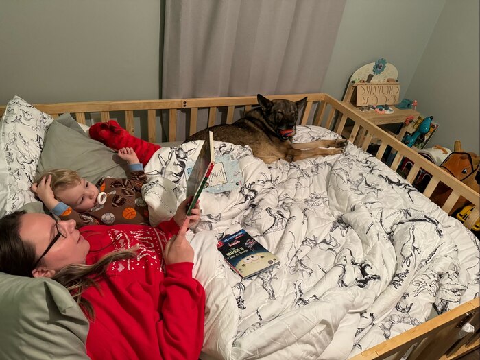 Family in bed with dog
