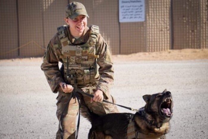 Airman with dog on leash