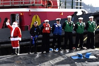 Santa waves on board USS Colorado (SSN 788) as the ship prepares to moor during a homecoming event in Groton, Conn., Dec. 19.