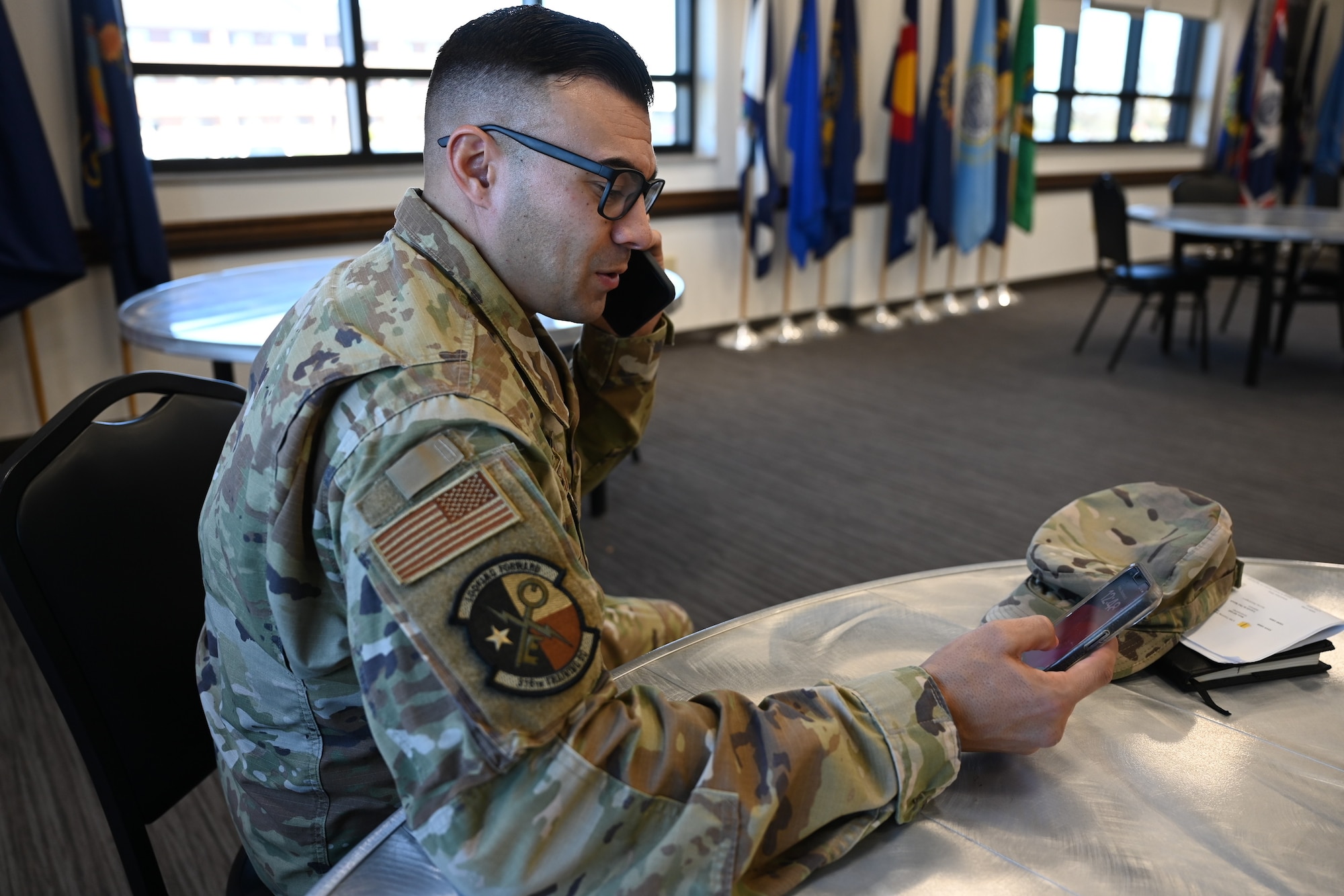 U.S. Air Force Chief Master Sgt. Christopher Campbell, 316th Training Squadron senior enlisted leader, answers a call on his duty cell at the Cressman Dining Facility, Goodfellow Air Force Base, Texas, Dec. 8, 2023. As the SEL, Campbell’s duties include maintaining the health, morale and welfare of unit members. (U.S. Air Force photo by Airman 1st Class Evelyn D'Errico)