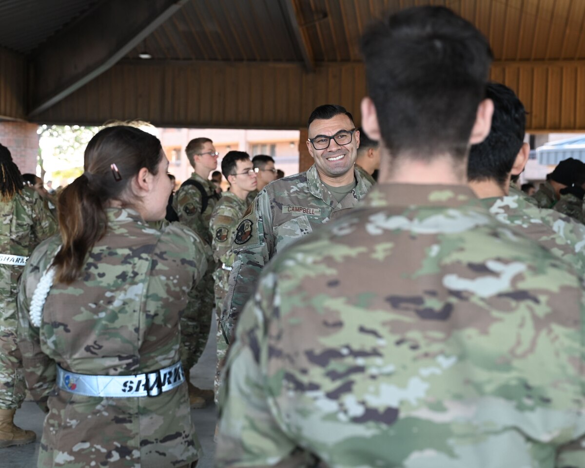 U.S. Air Force Chief Master Sgt. Christopher Campbell, 316th Training Squadron senior enlisted leader, talks with students assigned to the 316th TRS at an afternoon formation under the 316th TRS pavilion at Goodfellow Air Force Base, Texas, Dec. 7, 2023. As the SEL, Campbell’s duties include maintaining the health, morale and welfare of unit members. (U.S. Air Force photo by Airman 1st Class Evelyn D'Errico)