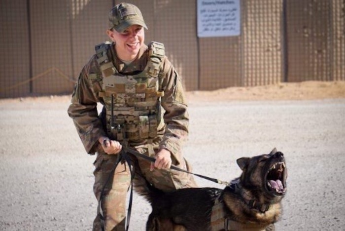 Airman with dog on leash