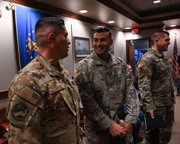 U.S. Air Force Chief Master Sgt. Christopher Campbell, 316th Training Squadron senior enlisted leader, talks with Chief Master Sgt. Robert Laning, 312th TRS senior enlisted leader before the 17th Training Wing brief at the Norma Brown headquarters building, Goodfellow, Air Force Base, Texas, Dec. 7, 2023. Campbell enlisted in the Air Force in 2006. (U.S. Air Force photo by Airman 1st Class Evelyn D'Errico)