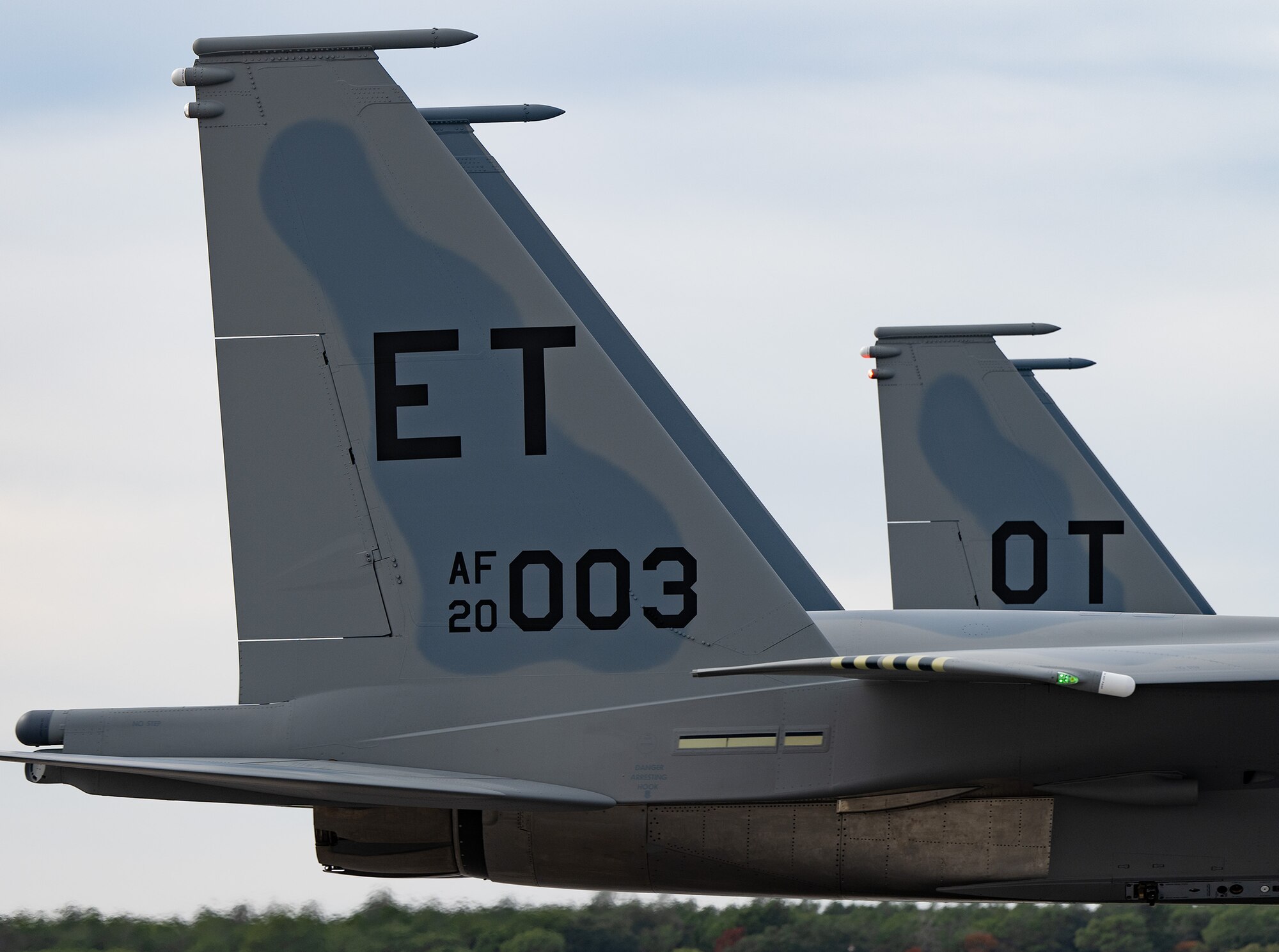 Two fighter jet tails cropped in tight.