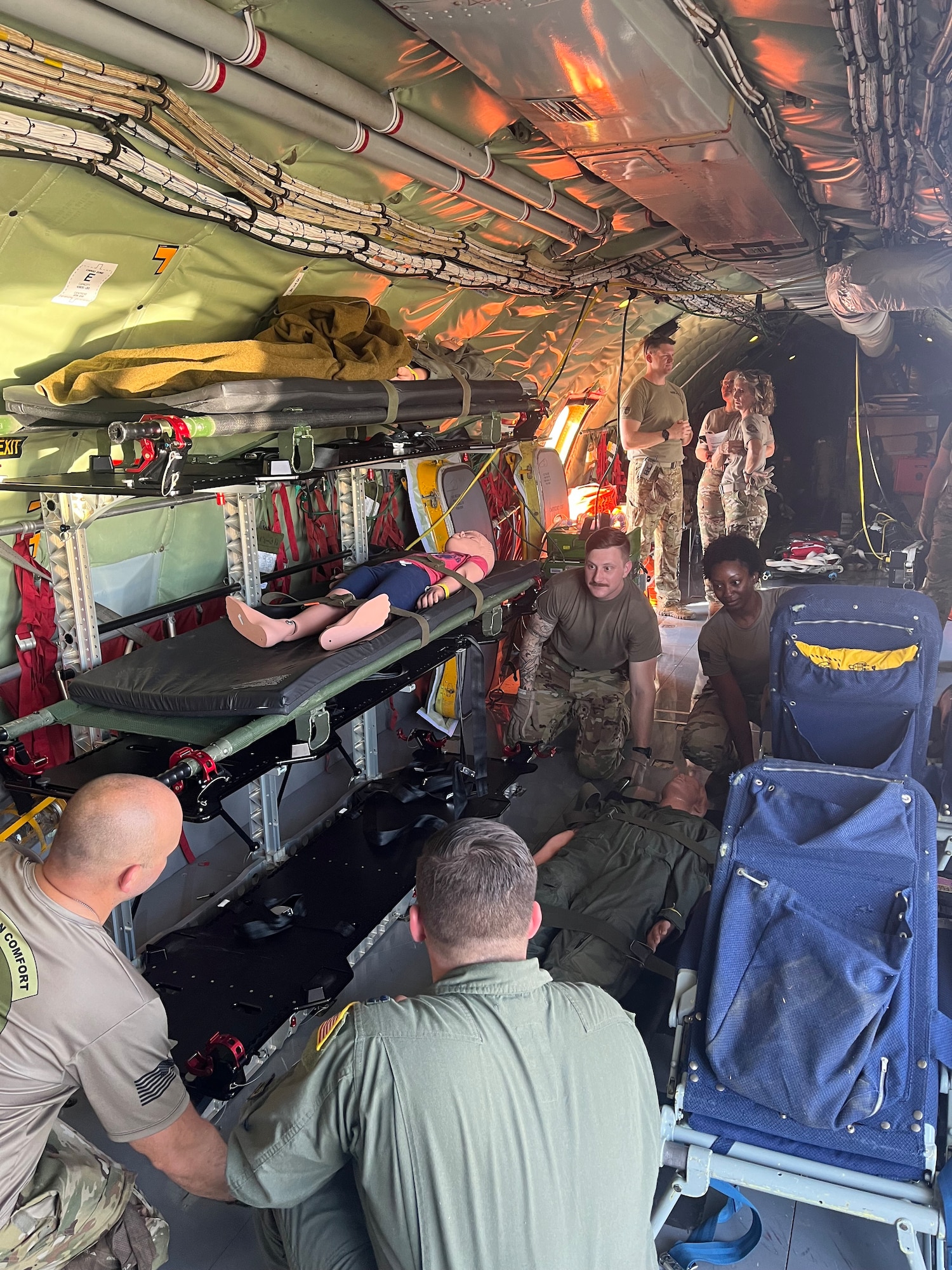 people prep an aircraft for training