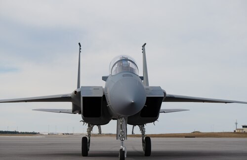 A F-15X Eagle aircraft's front nose taxies forward on the runway.