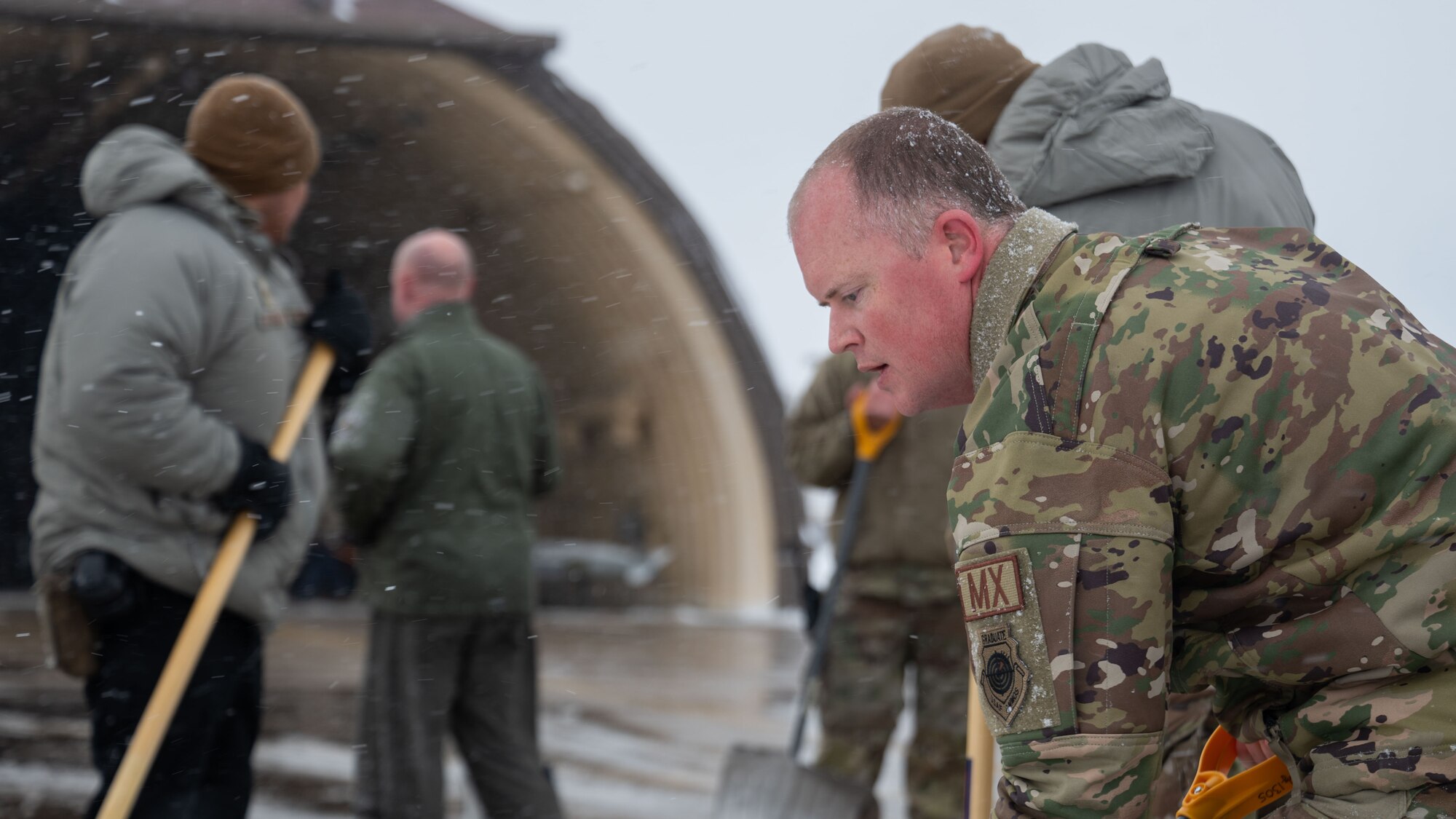 Airmen clear snow and ice from Kunsan Air Base