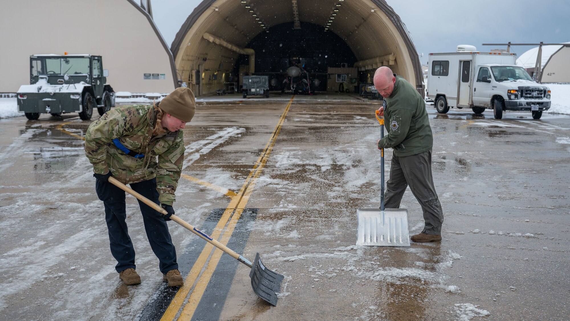 Airmen clear snow and ice from Kunsan Air Base