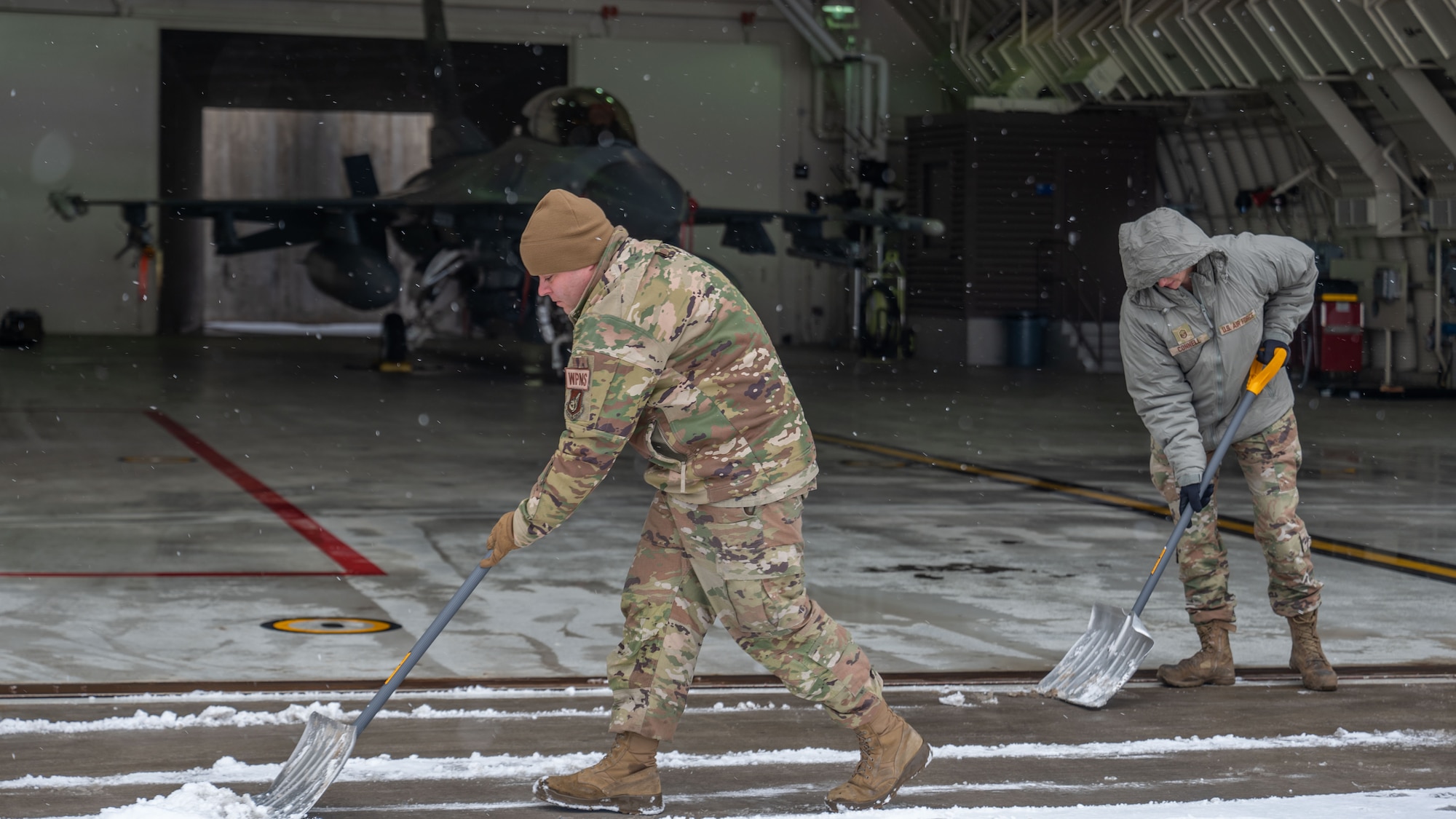 Airmen clear snow and ice from Kunsan Air Base