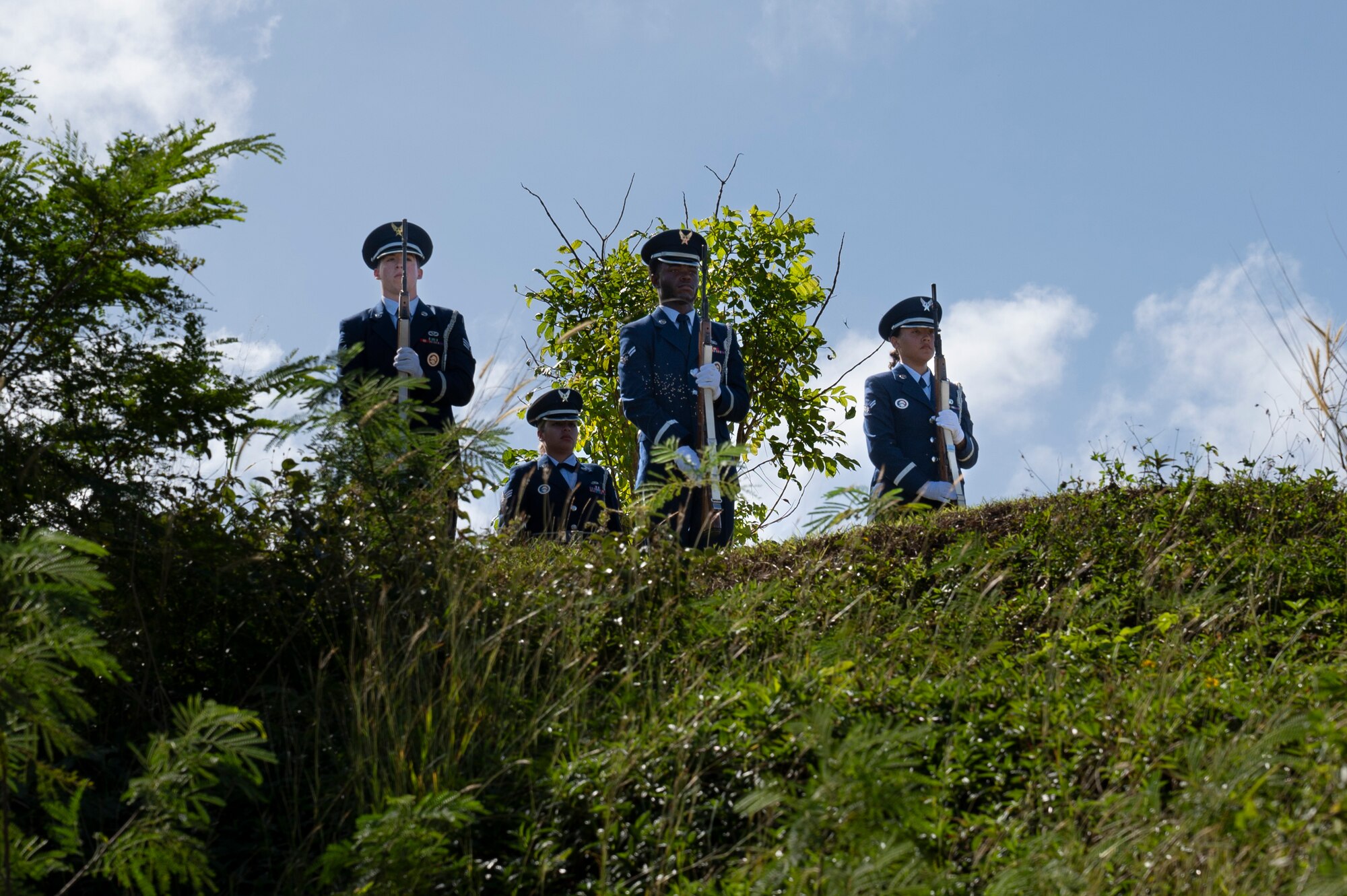 Andersen Air Force Base Honor Guard members perform a 21-gun salute during the Wreaths Across America ceremony at the Guam Veterans Cemetery, Guam, Dec. 16, 2023. The Wreaths Across America program allows families to honor and remember the sacrifices of our military Veterans by placing wreaths on their graves during the holiday season. (U.S. Air Force photo by Airman 1st Class Spencer Perkins)