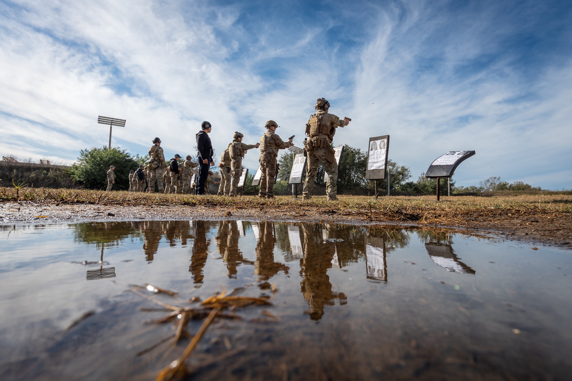 Airmen assigned to the 6th Civil Engineer Squadron explosive ordnance disposal flight and 6th Security Forces Squadron fire their weapons at the combat arms training and maintenance facility at MacDill Air Force Base, Florida, Dec. 12, 2023.
