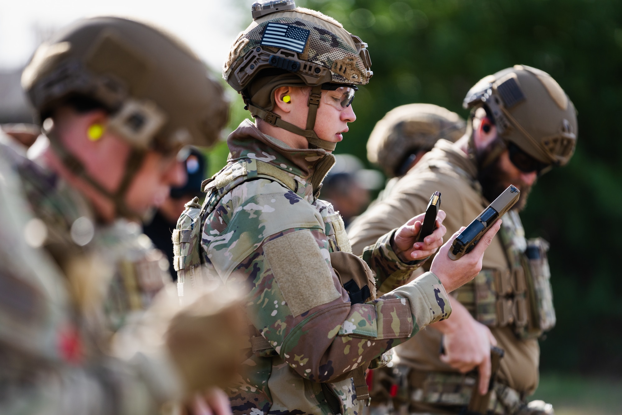 Airmen assigned to the 6th Civil Engineer Squadron explosive ordnance disposal flight and 6th Security Forces Squadron load their weapons at the combat arms training and maintenance facility at MacDill Air Force Base, Florida, Dec. 12, 2023.