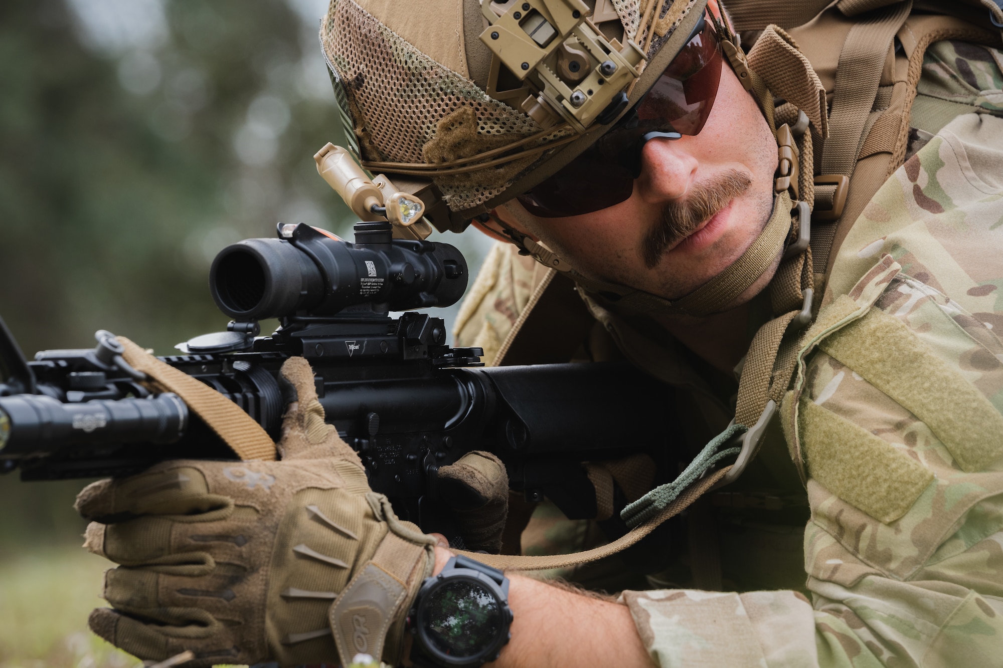 U.S. Air Force Senior Airman Alexander Kuri, 6th Civil Engineer Squadron explosive ordnance disposal technician, surveys the surrounding area during a dismounted exercise at MacDill Air Force Base, Florida, Dec. 14, 2023.