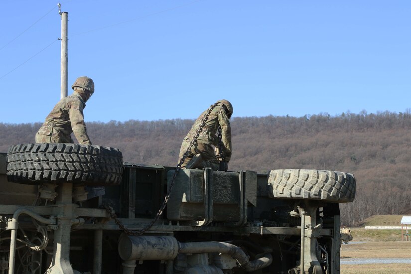 10th Mountain soldiers prepare to recover an overturned vehicle. Regional training Site Maintenance – Fort Indiantown Gap, under the 94th Training Division, partnered with the 1st Brigade Combat Team 10th Mountain Division in Fort Drum, NY, to ensure 16 active-duty soldiers received the wheeled recovery specialist additional skill identifier.