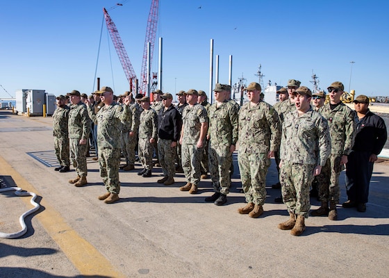 Capt. Jason Pittman, commodore, Submarine Squadron Six, leads Sailors in the battlecry for the Virginia-class fast-attack submarine USS Washington (SSN 787) as the boat prepares to moor pierside during its homecoming at Naval Station Norfolk, Dec. 15, 2023.