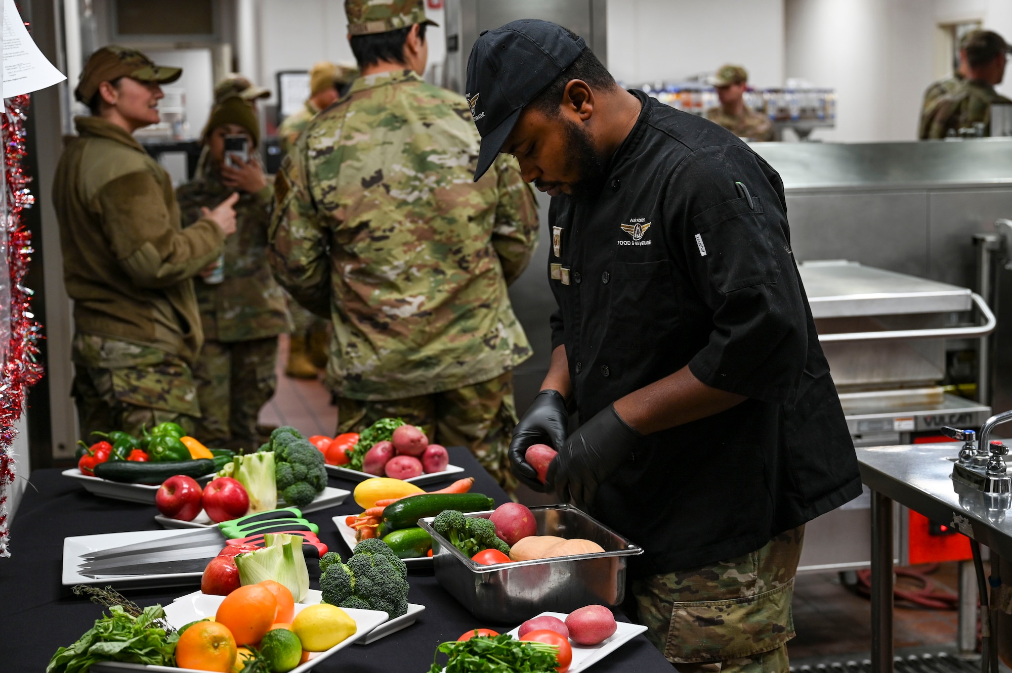 An Airman selects vegetables to cook.