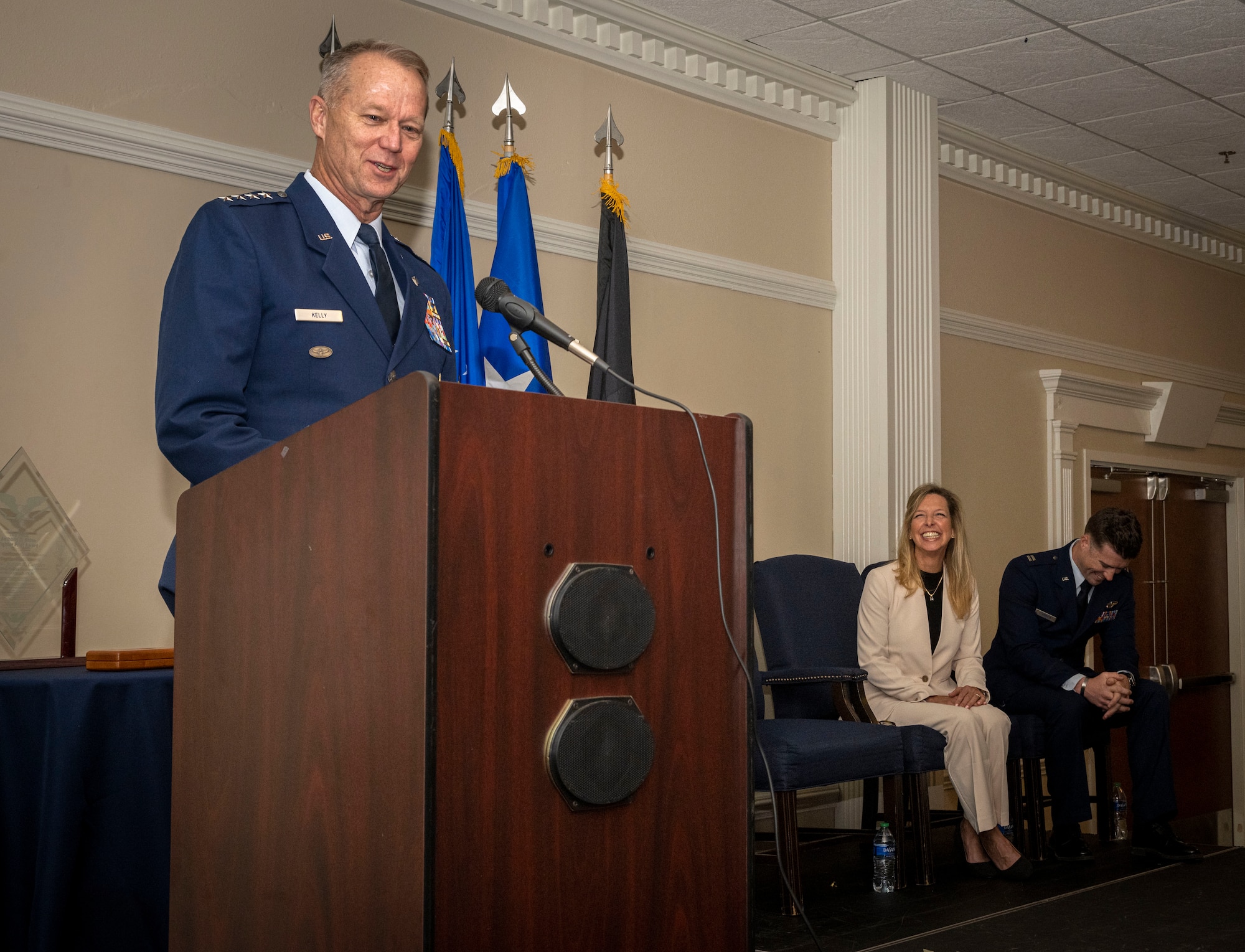 U.S. Air Force Gen. Mark Kelly, left, commander of Air Combat Command,  highlights the recipients accomplishments during a Lt. Col. Anthony C. Shine award ceremony at Seymour Johnson Air Force base, North Carolina, Dec. 15, 2023. In 1972, Shine went missing in action, his memory is honored through this award, which sets an example for Airmen today to uphold themselves to a higher standard of valor. (U.S. Air Force photo by Senior Airman Sabrina Fuller-Judd)