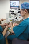 Then Navy Capt. (Dr.) Joseph Pasternak performs eye surgery at Walter Reed National Military Medical Center.