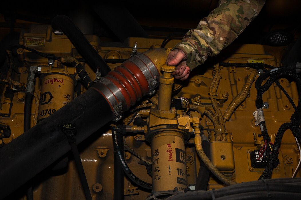 U.S. Air Force Airman 1st Class Elizabeth Opell, 354th Civil Engineering Squadron pavement and equipment specialist, checks the oil on a snow broom before departing to the flightline on Eielson Air Force Base, Alaska, Dec. 19, 2023. The snow brooms run 24/7 shifts to ensure the flightline is clear to deploy aircraft in support of Pacific Air Forces and United States Indo-Pacific Command missions. (U.S. Air Force photo by Airman Spencer Hanson)