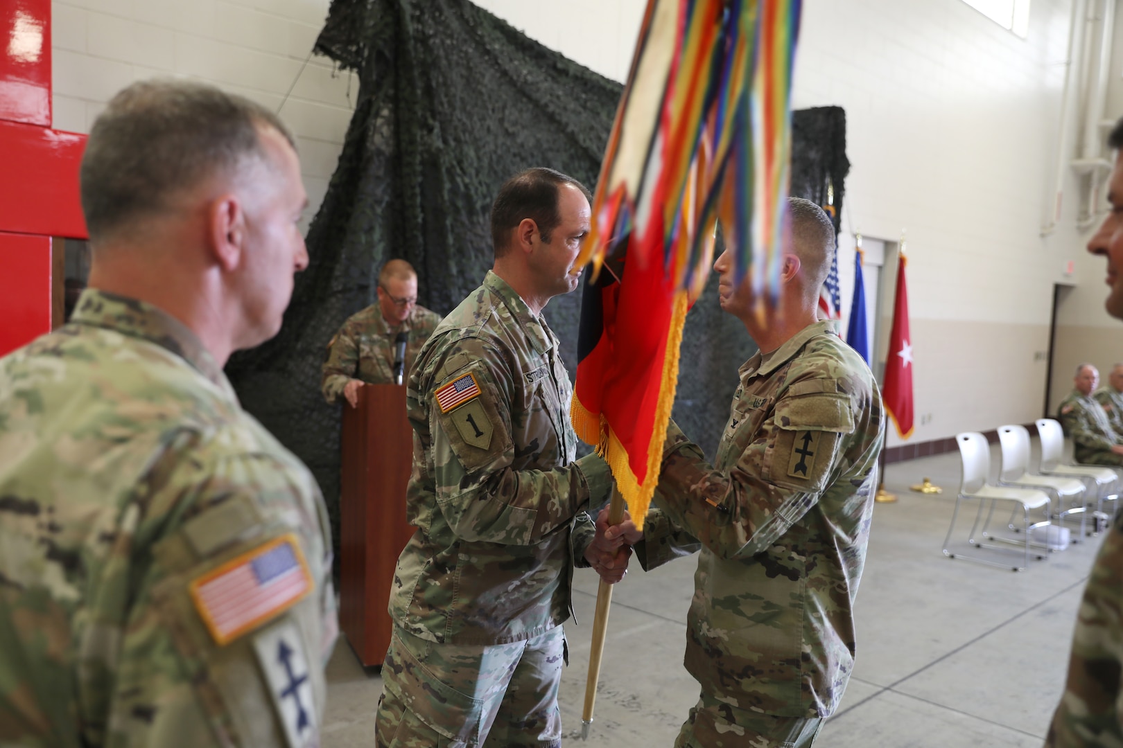 Brig. Gen. Matthew Strub, Wisconsin’s deputy adjutant general for Army, transfers the colors for the Wisconsin Army National Guard’s 32nd “Red Arrow” Infantry Brigade Combat Team to incoming commander Col. Matthew Elder during an Aug. 6 change of command ceremony at the brigade headquarters near Camp Douglas, Wis. The 32nd Brigade is the largest brigade in the Wisconsin Army National Guard, and is a basic, deployable U.S. Army combat unit resembling a small-scale combat division with infantry, cavalry, field artillery and special troops units for intelligence, signal, military police and combat engineers. Wisconsin National Guard photo by Staff Sgt. Kati Volkman