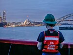 U.S. Coast Guard Seaman Apprentice Mary Wysong looks at the Sydney Opera House while standing on the bow of the U.S. Coast Guard Cutter Polar Star (WAGB 10) as it pulls into Sydney, Australia, Dec. 10, 2023. U.S. Coast Guard Cutter Polar Star is en route to Antarctica in support of Operation Deep Freeze, a joint service, inter-agency support operation for the National Science Foundation, which manages the United States Antarctic Program. (U.S. Coast Guard photo by Petty Officer 3rd Class Ryan Graves)