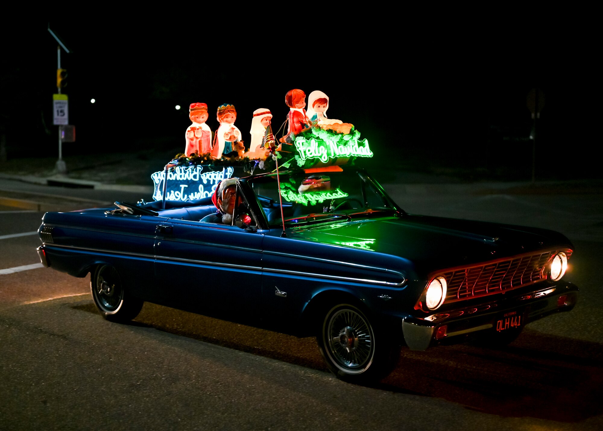 Parade participants cruise by and wave at families during the 2023 Holiday Parade at Vandenberg Space Force Base.