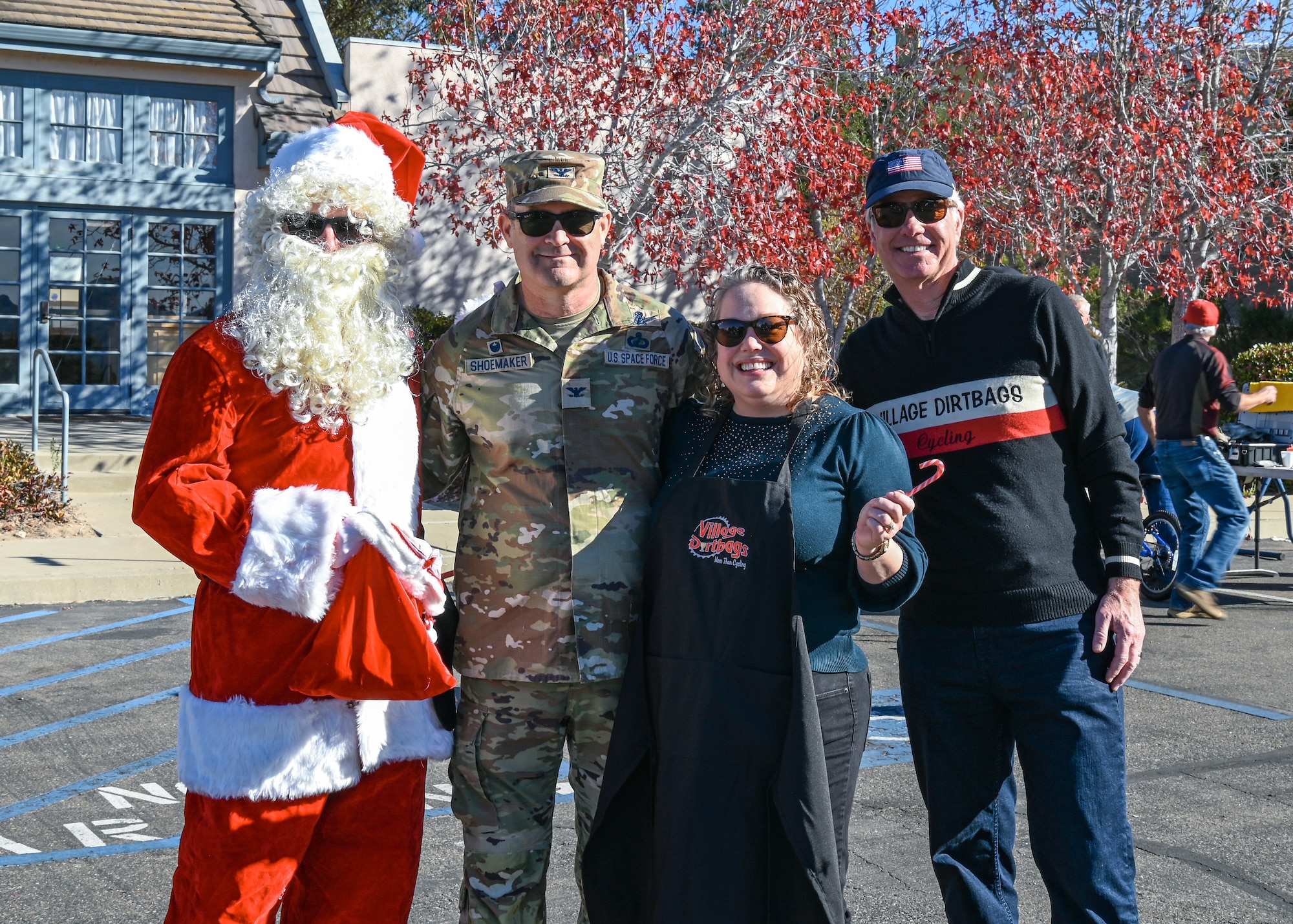 Space Launch Delta 30 commander (center), Mary Shoemaker, SLD 30 commander’s wife (center), Santa Claus, Worldwide cheer bringer (left), and Roger McConnell, Village Dirtbags lead coordinator for Vandenberg military families (right), pose for photo during the Holiday Bike Give away.