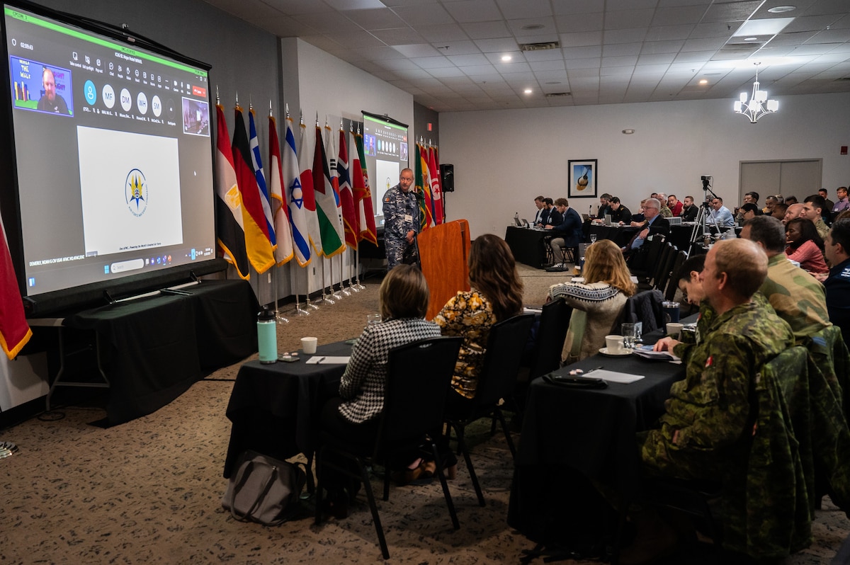 Individuals watching PowerPoint presentation.