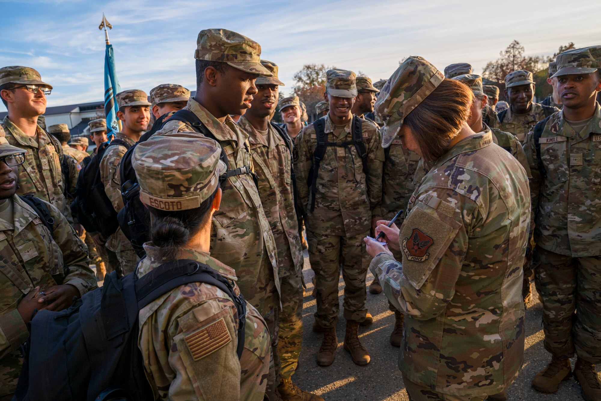 Chief Master Sgt. of the Air Force JoAnne S. Bass signs a paper for a student Airman on Keesler Air Force Base, Mississippi, Dec. 19, 2023.