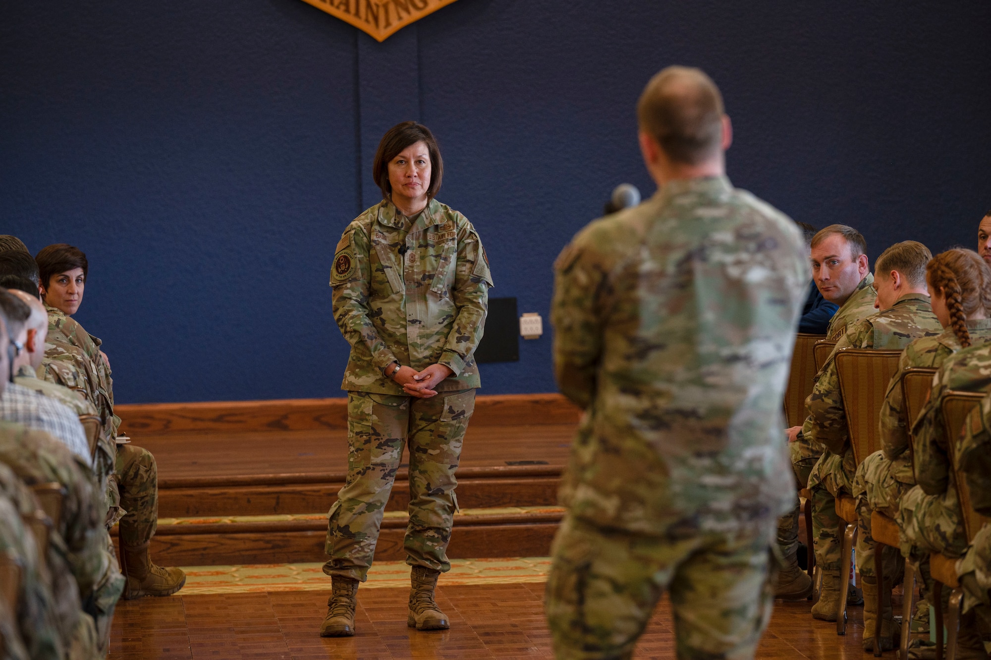 Chief Master Sgt. of the Air Force JoAnne S. Bass listens to question from 81st Training Wing Airman during an all-call on Keesler Air Force Base, Mississippi, Dec. 19, 2023.