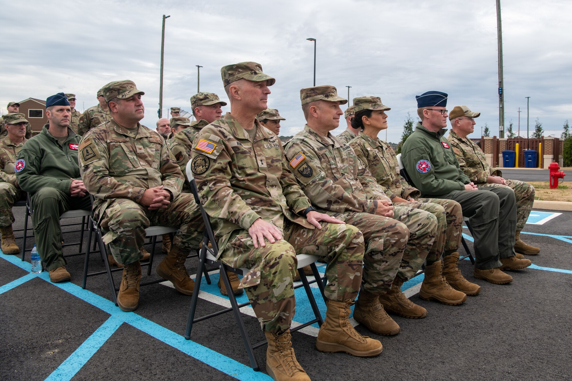 Military members sitting in audience.