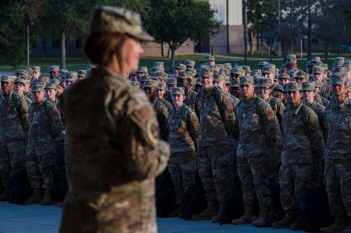 Chief Master Sgt. of the Air Force JoAnne S. Bass poses for a photo with student Airmen on Keesler Air Force Base, Mississippi, Dec. 19, 2023.