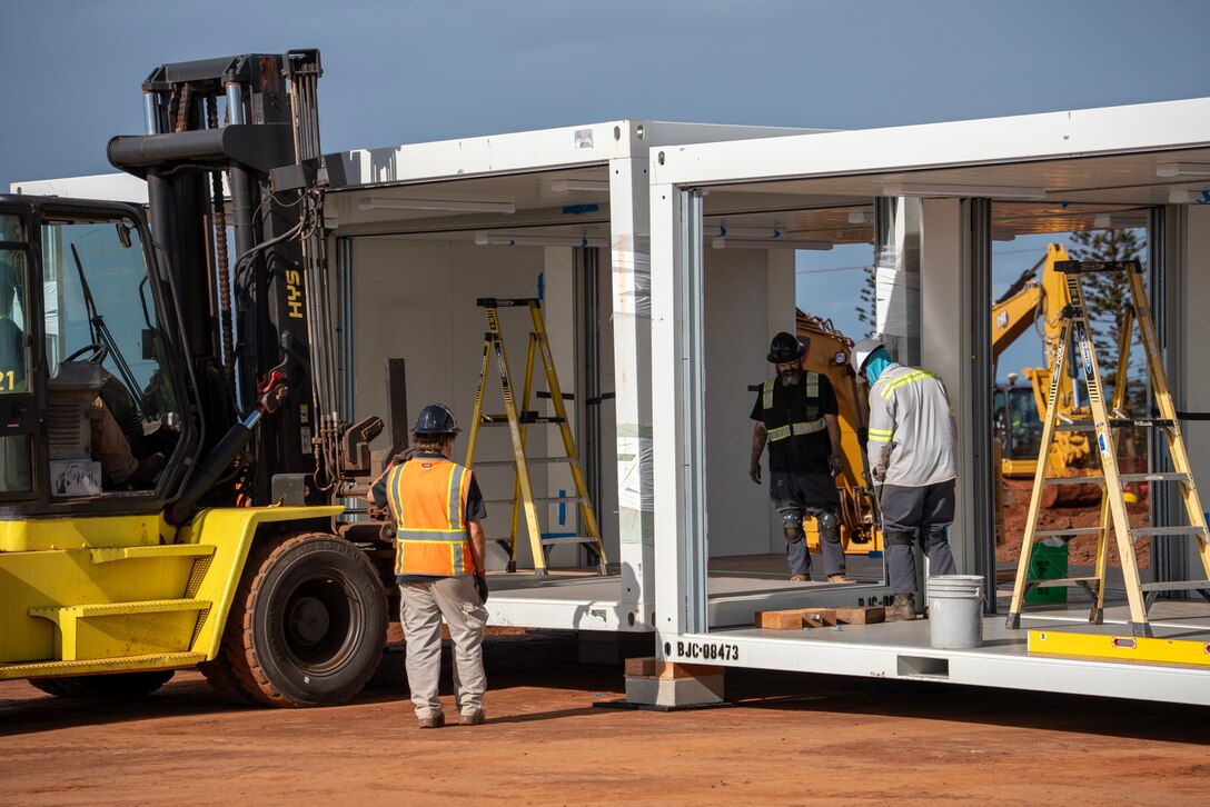 Contractors assemble a modular frame into a classroom at the temporary replacement campus for King Kamehameha III Elementary School, Dec. 16, 2023 in Lahaina, Hawaii.