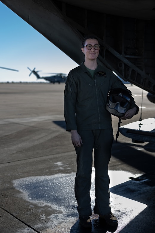 U.S. Marine Corps Sgt. Rachel Myers, a crew chief with Marine Heavy Helicopter Squadron (HMH) 361, Marine Aircraft Group 16, 3rd Marine Aircraft Wing, poses for a photo in front of a CH-53E Super Stallion at Marine Corps Air Station, California, Dec. 5, 2023. As a crew chief, Myers communicates with pilots about in-flight instructions, alerts to any obstacles not visible from the pilot's point of view and works within the maintenance department where they inspect, service, maintain, and repair helicopters. (U.S. Marine Corps photo by Lance Cpl. Samantha Devine)