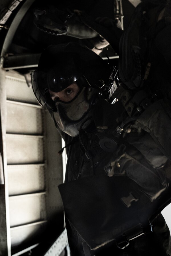 U.S. Marine Corps Sgt. Rachel Myers, a crew chief with Marine Heavy Helicopter Squadron (HMH) 361, Marine Aircraft Group 16, 3rd Marine Aircraft Wing, puts on flight vest in a CH-53E Super Stallion at Marine Corps Air Station, California, Dec. 13, 2023. As a crew chief, Myers communicates with pilots about in-flight instructions, alerts to any obstacles not visible from the pilot's point of view and works within the maintenance department where they inspect, service, maintain, and repair helicopters. (U.S. Marine Corps photo by Lance Cpl. Samantha Devine)