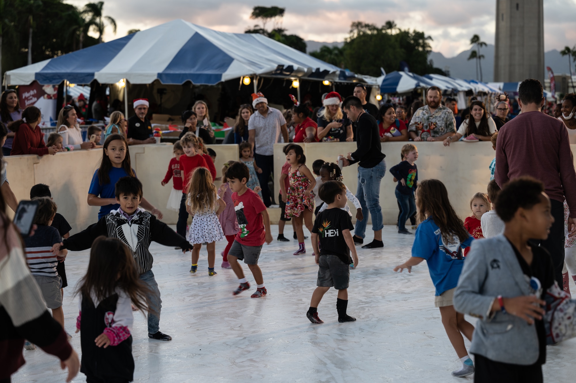 Service members and their families celebrate the start of the holiday season during the Freedom Tower Lighting Celebration at Joint Base Pearl Harbor-Hickam Hawaii, Dec. 15, 2023. Members from JBPHH participated in ice skating, a snow zone, and arts and crafts before the annual tower lighting. (U.S. Air Force photo by Staff Sgt. Alan Ricker)