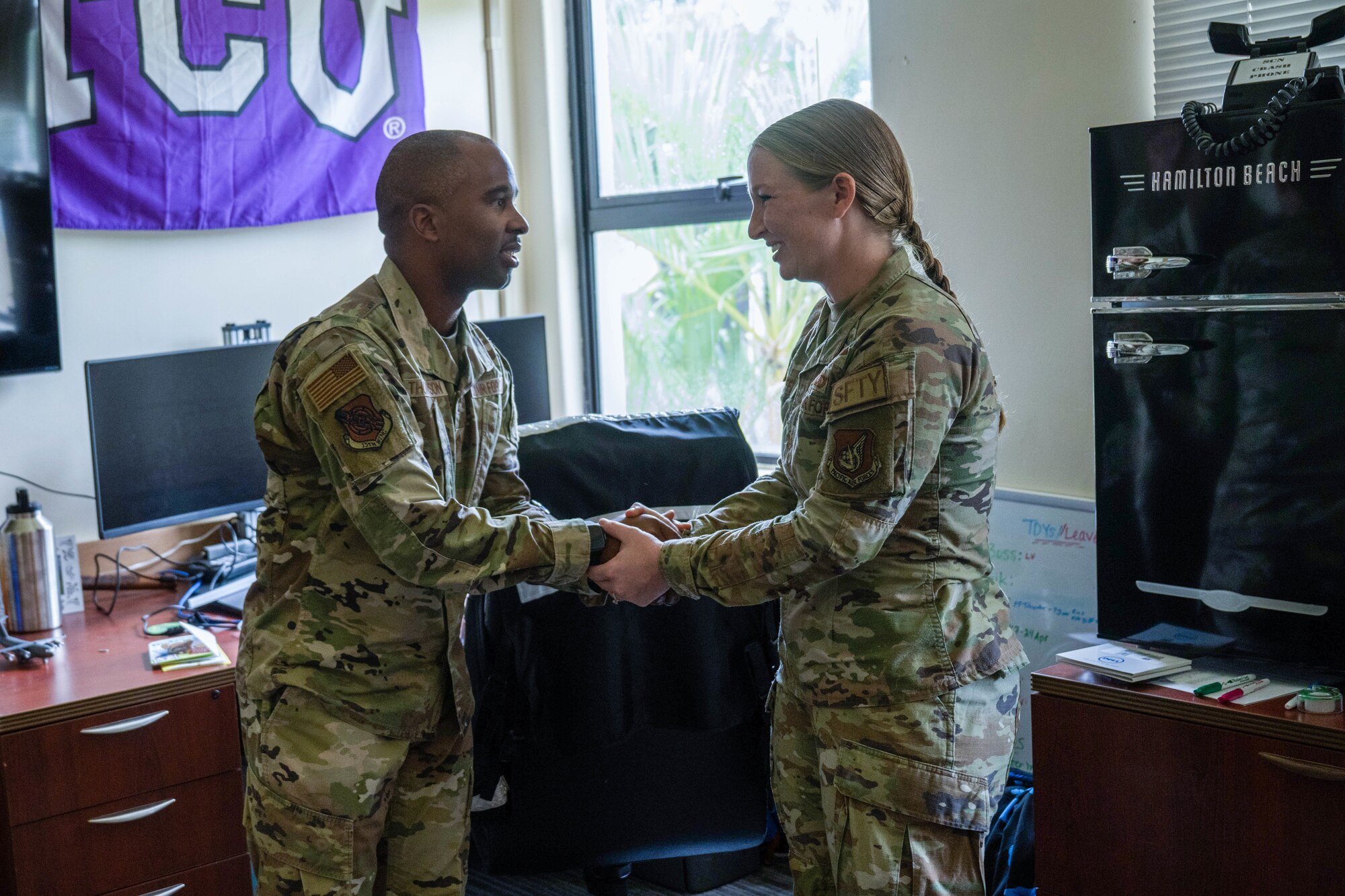 Tech Sgt. Taylor Huff, 15th Wing occupational safety manager, is recognized by Chief Master Sgt. Anthony Thompson, 15th Wing command chief, at Joint Base Pearl Harbor-Hickam, Hawaii, Dec. 20, 2023. Huff was recognized as December’s Sky Warrior of the Month for her initiative in leading an investigation that resulted in policy changes, and managing a team of 14 members across four different moral events. (U.S. Air Force photo by Senior Airman Makensie Cooper)