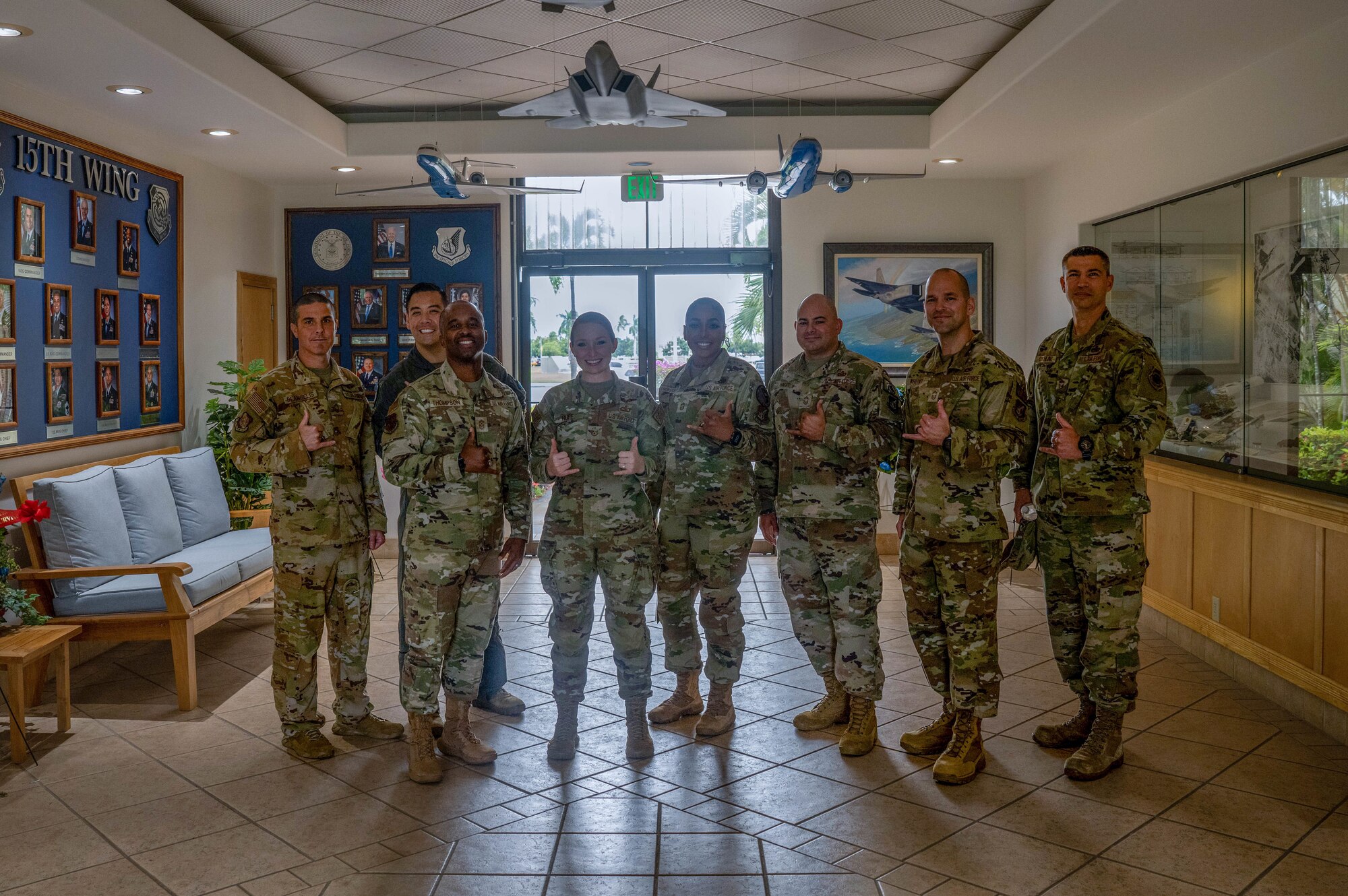 Tech Sgt. Taylor Huff, 15th Wing occupational safety manager, poses for a group photo with Chief Master Sgts. assigned to Hickam Field at Joint Base Pearl Harbor-Hickam, Hawaii, Dec. 19, 2023. Huff was recognized as December’s Sky Warrior of the Month for single handedly leading an investigation that resulted in policy changes, and managing a team of 14 members across four different moral events. (U.S. Air Force photo by Senior Airman Makensie Cooper)