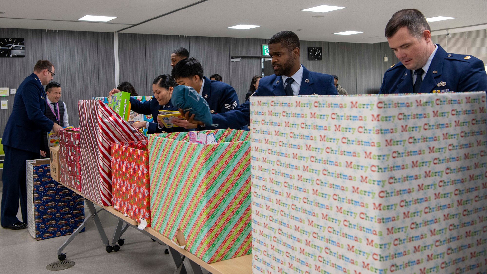 Airmen organize gifts on tables.