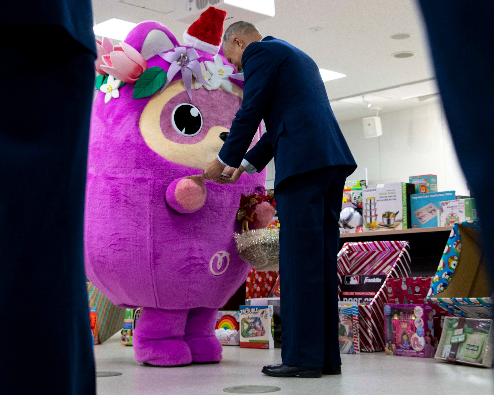 An Air Force officer receives a gift from the Mizuho town official character.