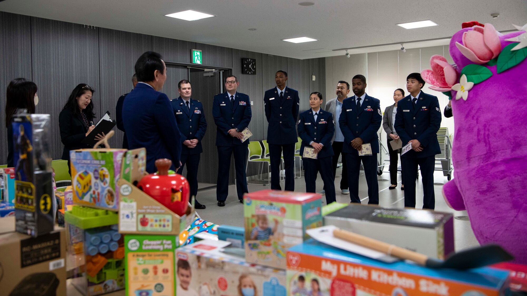 A group of Airmen listen to remarks from the Mizuho town mayor.