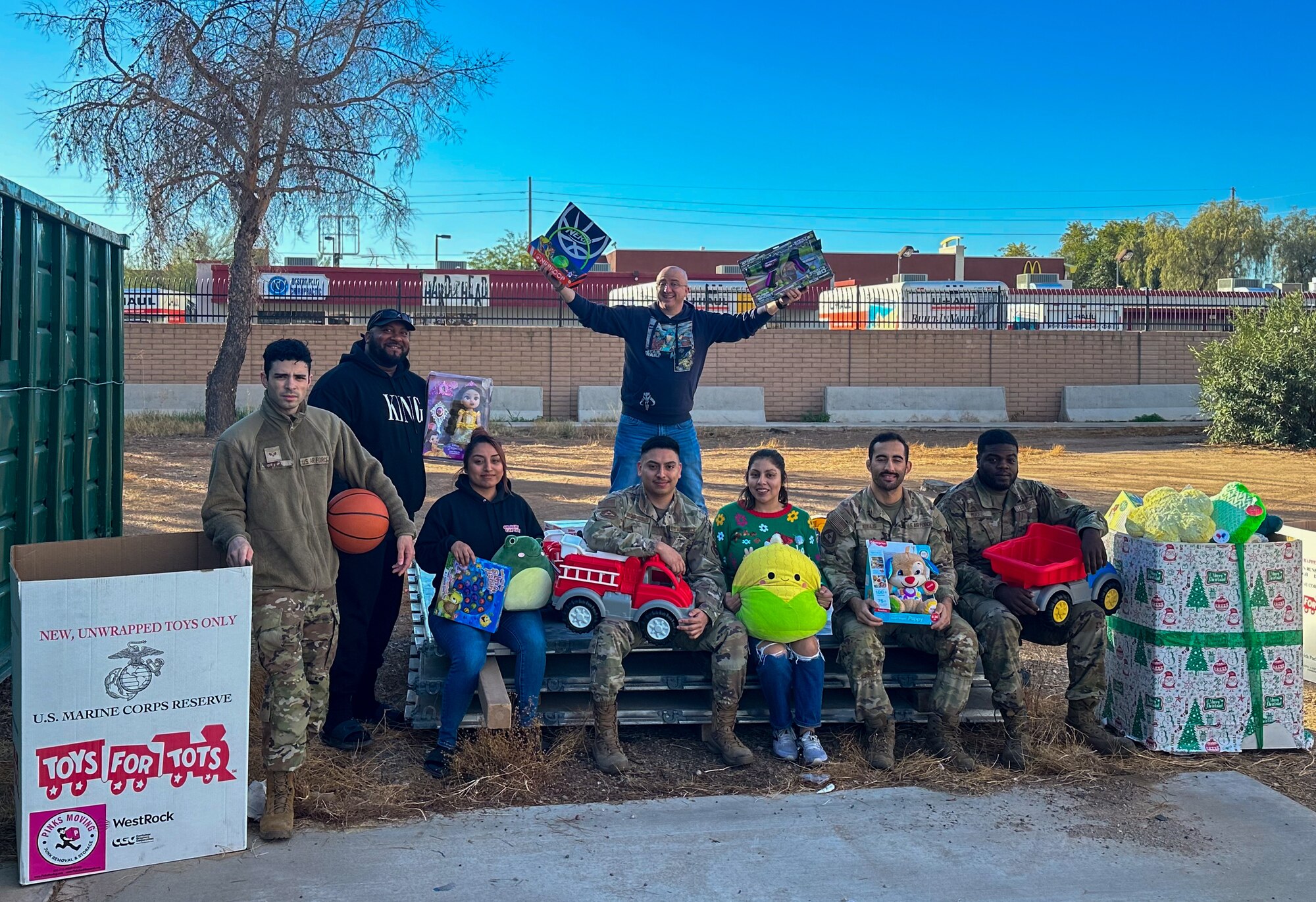 Volunteers for a Toys for Tots event pose for a group photo Dec. 21-22, 2023, at Luke Air Force Base, Arizona.
