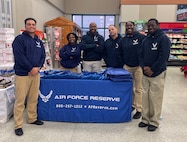 315 AW recruiters help spread holiday cheer at commissary