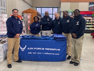 315 AW recruiters help spread holiday cheer at commissary