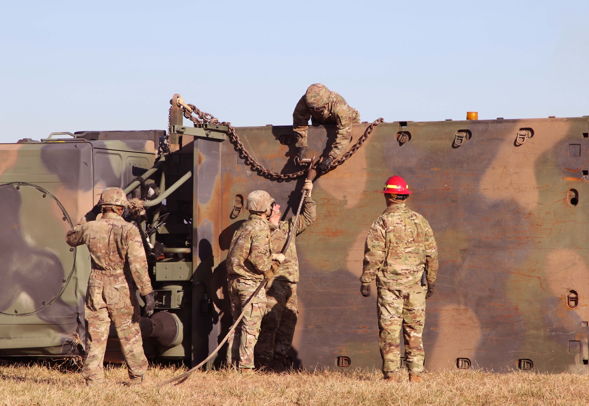 Instructors ensure safety protocols are being utilized while soldiers conduct overturned vehicle operations. Regional training Site Maintenance – Fort Indiantown Gap, under the 94th Training Division, partnered with the 1st Brigade Combat Team 10th Mountain Division in Fort Drum, NY, to ensure 16 active-duty soldiers received the wheeled recovery specialist additional skill identifier.
