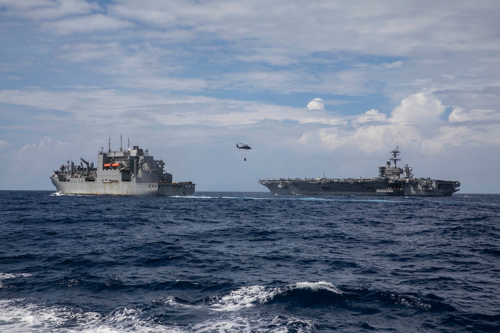 USS Carl Vinson (CVN 70) conducts a vertical replenishment with USNS Wally Schirra (T-AKE 8) in the South China Sea.